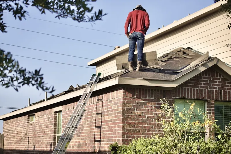 Professional roofer working on a residential roof in The Moorings